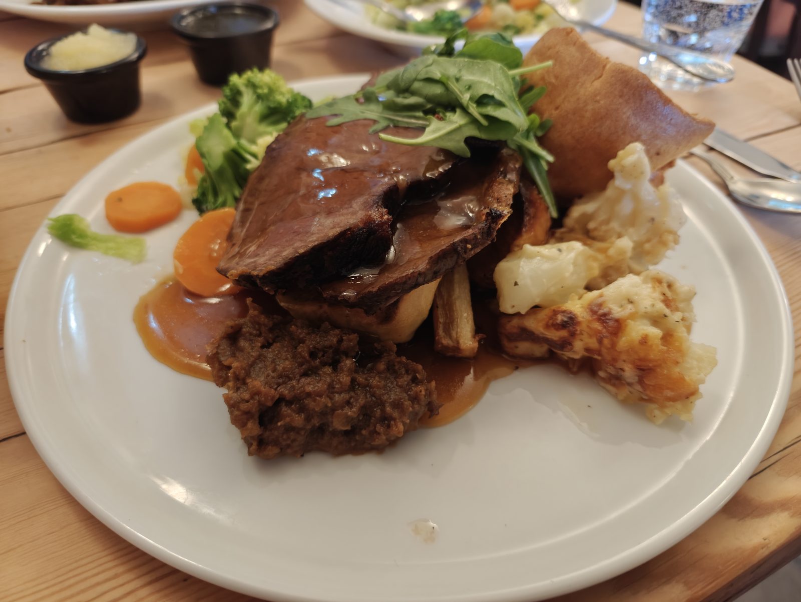 Stacked roast dinner with plenty of gravy